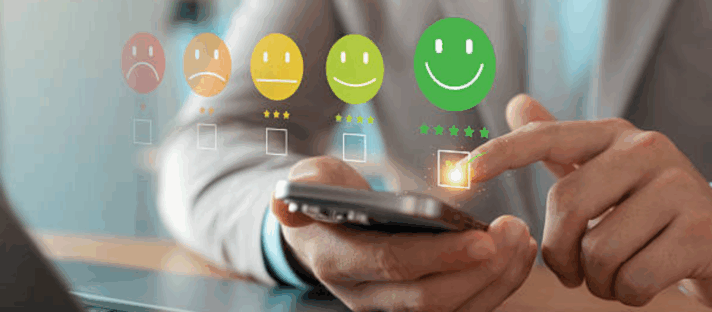 Hand selecting a five-star happy face review on a mobile phone screen, illustrating excellent online reputation for your clinic and patient satisfaction management.